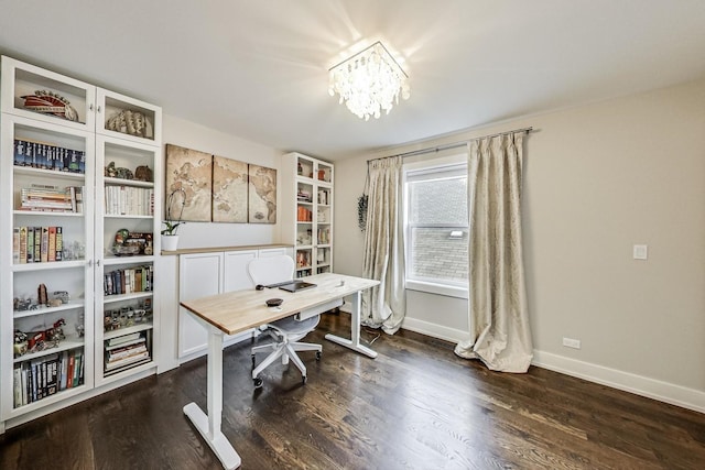 office space with dark wood-type flooring, baseboards, and an inviting chandelier