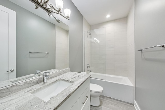 bathroom featuring toilet, bathing tub / shower combination, wood finished floors, and vanity