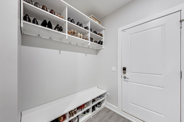 mudroom featuring light wood-style flooring and baseboards