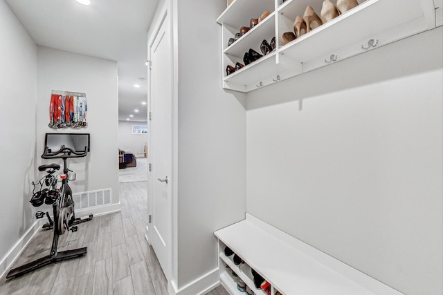 mudroom with light wood-style floors, recessed lighting, and baseboards