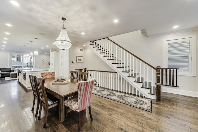 dining area featuring baseboards, dark wood-style floors, an inviting chandelier, stairs, and recessed lighting