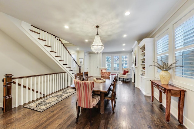 dining room with dark wood-style floors, stairway, an inviting chandelier, and recessed lighting