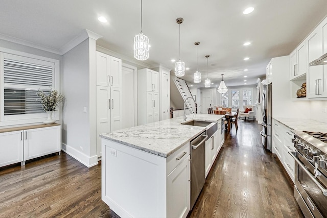 kitchen featuring a center island with sink, appliances with stainless steel finishes, dark wood finished floors, and recessed lighting