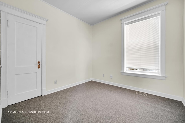 carpeted spare room with baseboards and visible vents