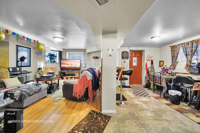 living room featuring visible vents and tile patterned floors