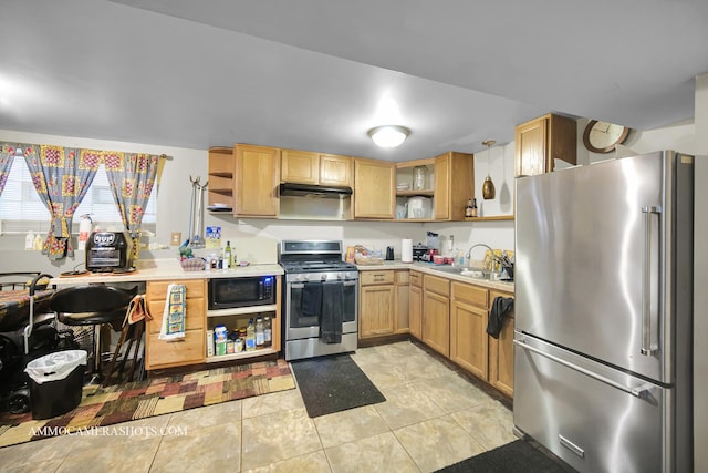 kitchen featuring light tile patterned floors, appliances with stainless steel finishes, light countertops, open shelves, and a sink