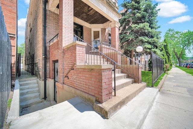 entrance to property featuring brick siding