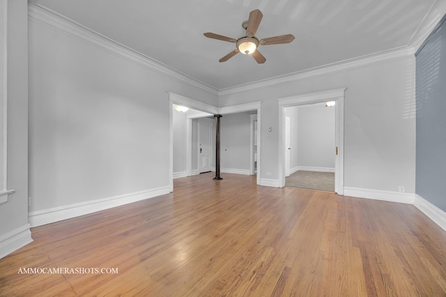 interior space featuring ceiling fan, baseboards, crown molding, and wood finished floors