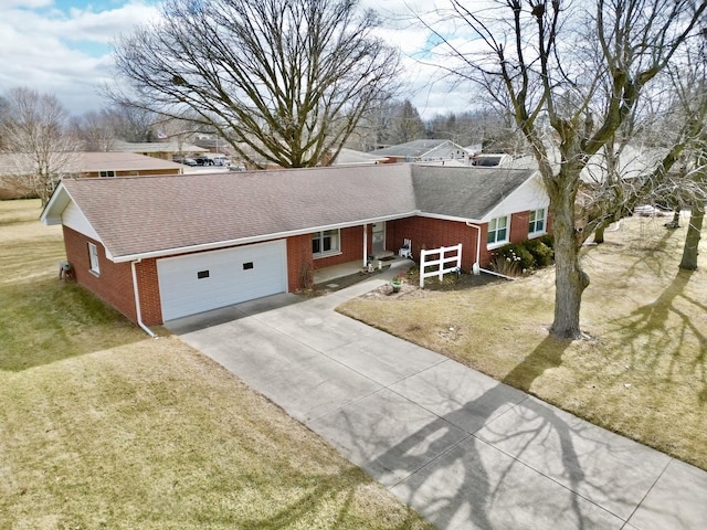 ranch-style home featuring a shingled roof, a front lawn, and brick siding