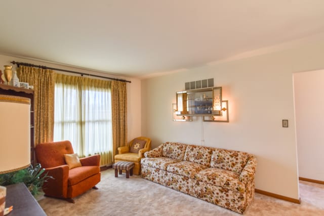 carpeted living room with baseboards and visible vents