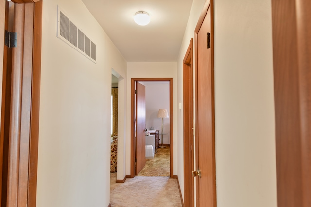 corridor featuring visible vents and light colored carpet