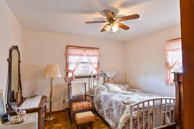 bedroom featuring ceiling fan and baseboards