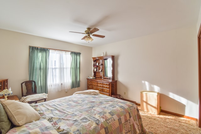 bedroom featuring carpet floors, baseboards, and a ceiling fan