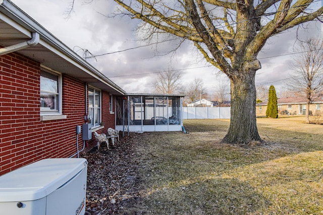 view of yard with fence and a sunroom