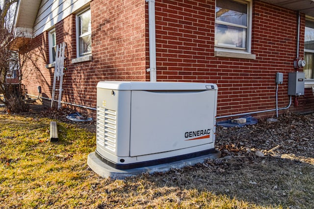 details featuring a power unit and brick siding