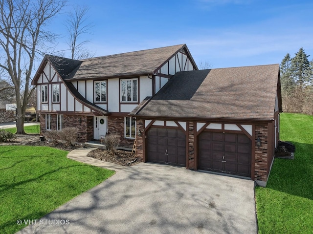 tudor home with a front yard, roof with shingles, driveway, stucco siding, and a garage