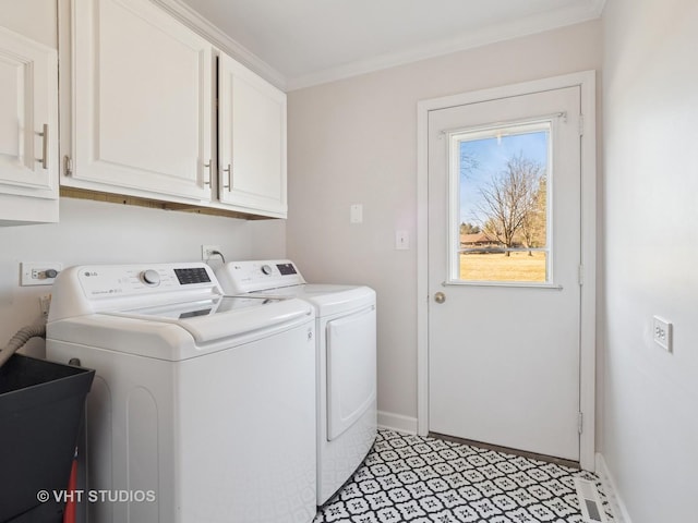 clothes washing area with light floors, baseboards, washing machine and clothes dryer, cabinet space, and ornamental molding