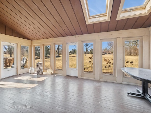 unfurnished sunroom featuring lofted ceiling with skylight and wood ceiling