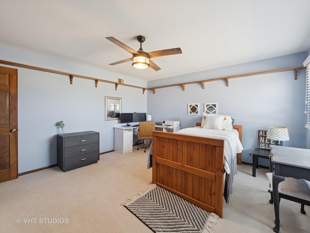 bedroom featuring light carpet, baseboards, and a ceiling fan