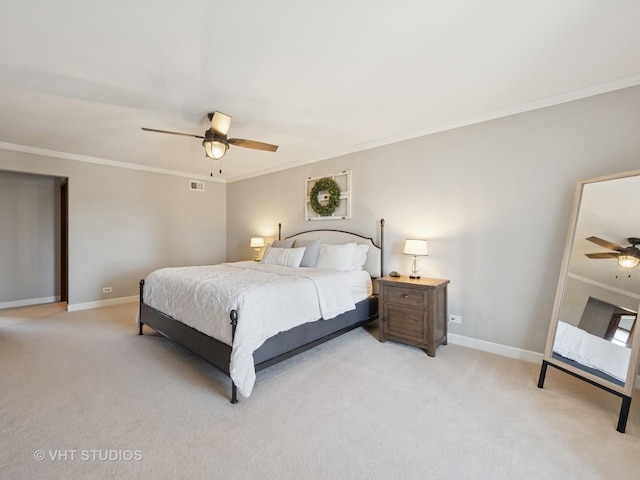 bedroom featuring visible vents, light colored carpet, baseboards, and ornamental molding