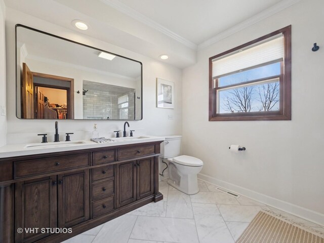 full bathroom with a sink, baseboards, toilet, and ornamental molding