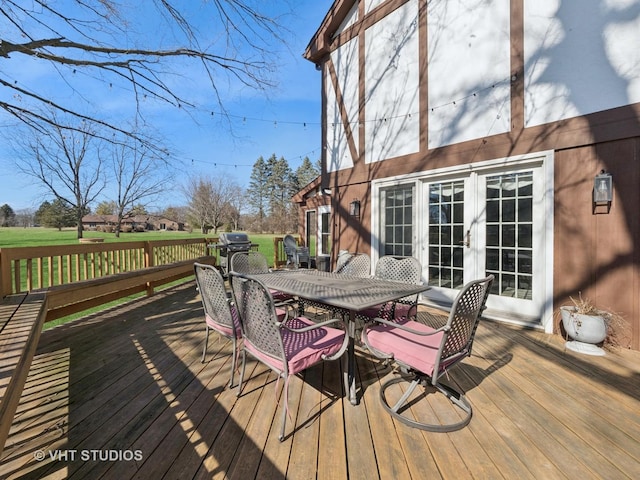 wooden deck featuring french doors and outdoor dining area