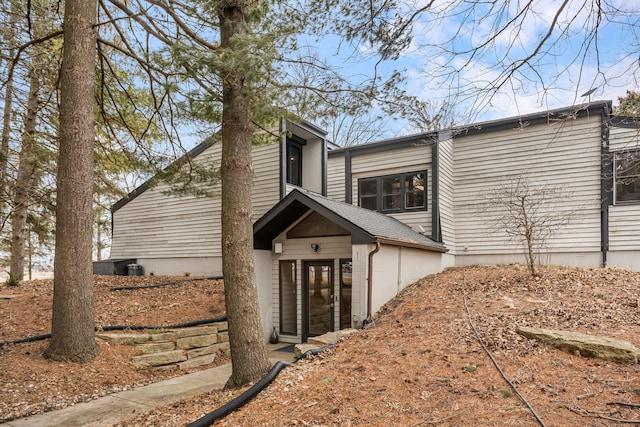 view of property exterior featuring a shingled roof