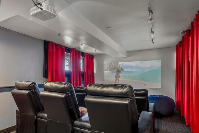 home theater with beam ceiling and rail lighting