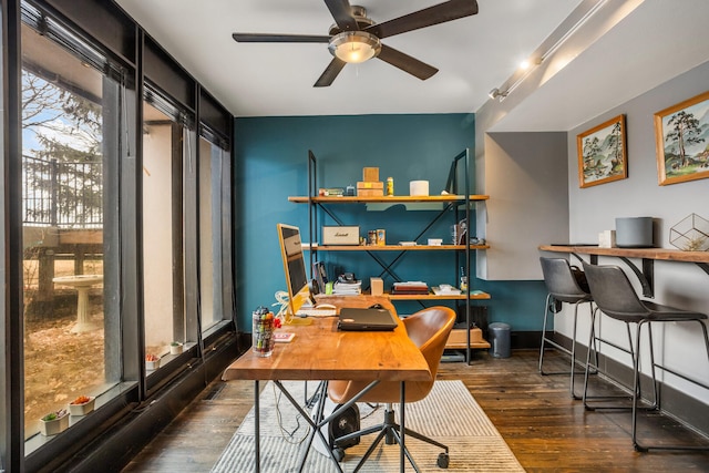 office space with a ceiling fan, wood finished floors, and baseboards