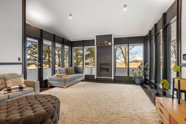 sunroom / solarium with a fireplace