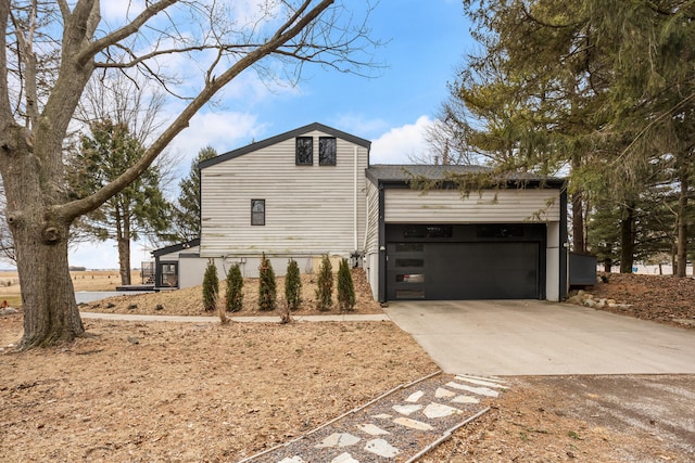 view of home's exterior featuring a garage and driveway