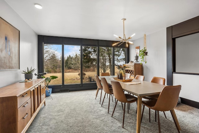 dining area featuring visible vents, light carpet, plenty of natural light, and a chandelier