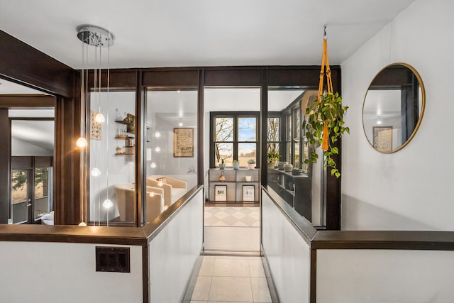 interior space featuring decorative light fixtures and light tile patterned floors