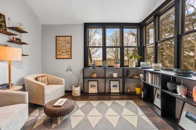 sitting room with lofted ceiling and wood finished floors