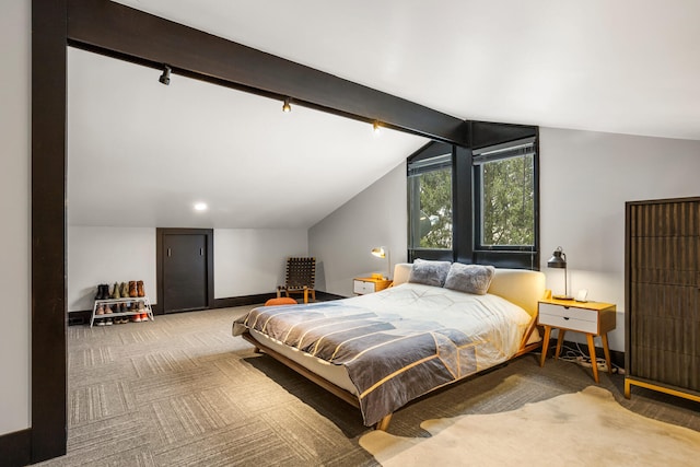 bedroom featuring lofted ceiling with beams, baseboards, and carpet floors