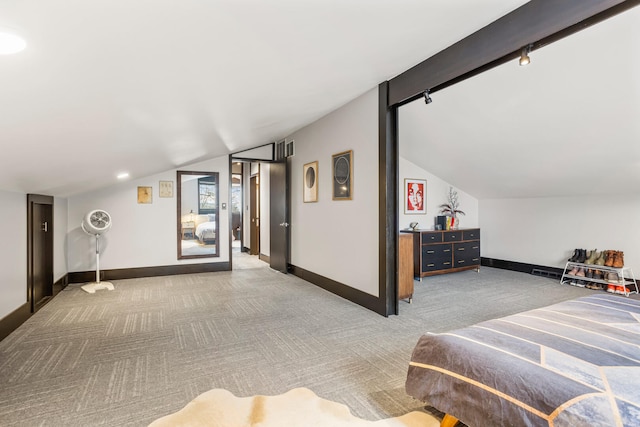 bedroom featuring baseboards, carpet, and vaulted ceiling