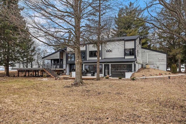 view of front of property with stairway, a garage, and a deck