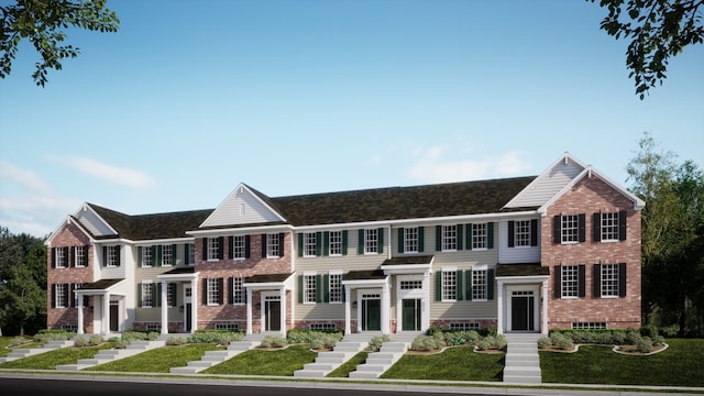 view of property with brick siding and a front yard