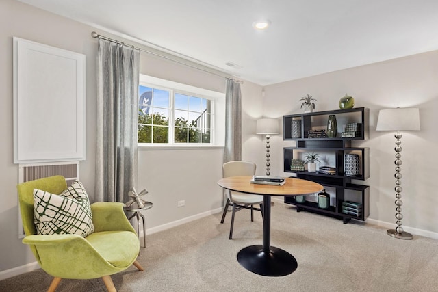 carpeted office space with visible vents and baseboards