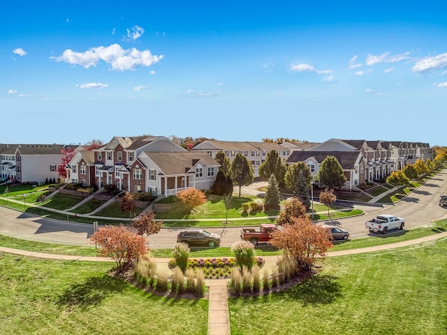 view of property's community with a residential view and a lawn