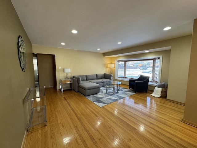 living area with light wood-style flooring and recessed lighting