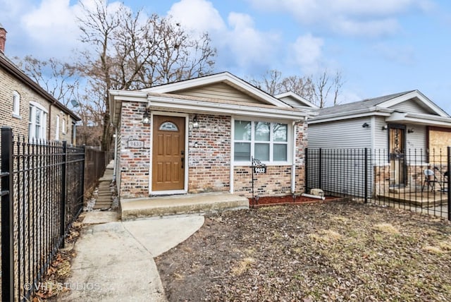 view of front of property featuring brick siding and fence private yard