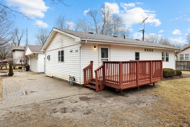 back of property with fence and a deck