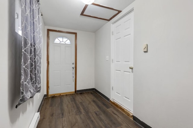 foyer with baseboard heating, baseboards, and wood finished floors