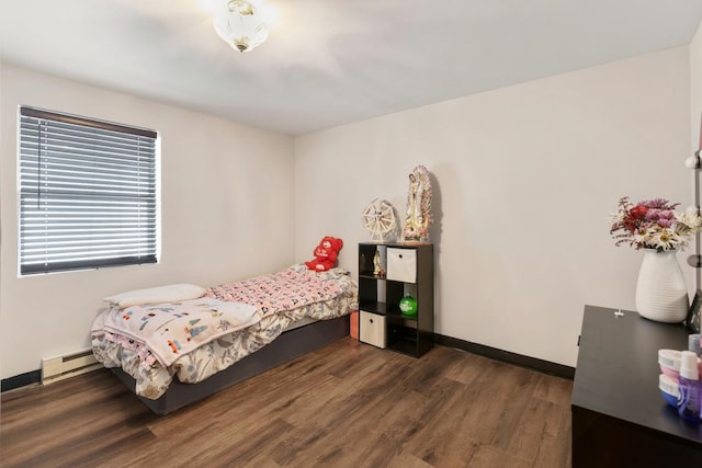 bedroom featuring baseboards, baseboard heating, and wood finished floors