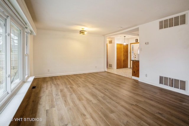 empty room with visible vents and wood finished floors