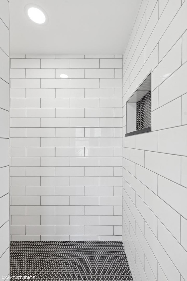 full bath with a tile shower