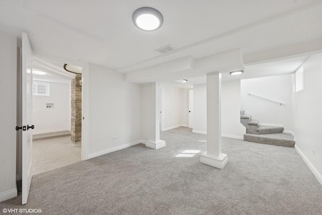 finished basement featuring carpet, stairs, and baseboards