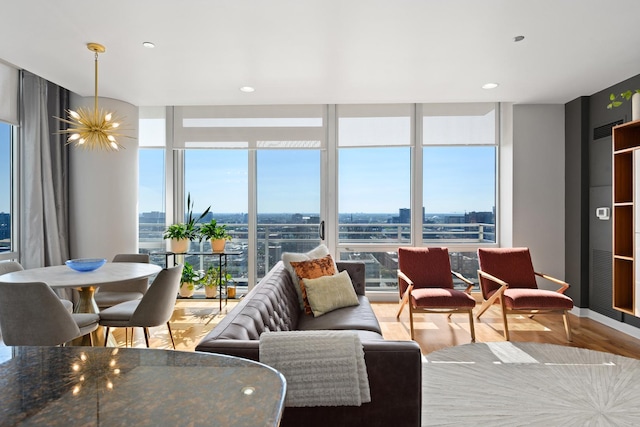 living area with expansive windows, a view of city, a chandelier, and a wealth of natural light