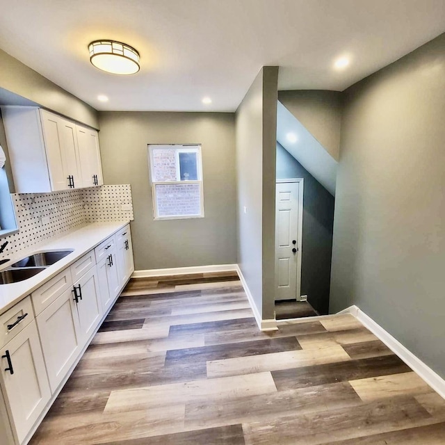 kitchen with baseboards, tasteful backsplash, and white cabinets